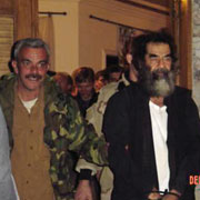 Saddam Handcuffed.